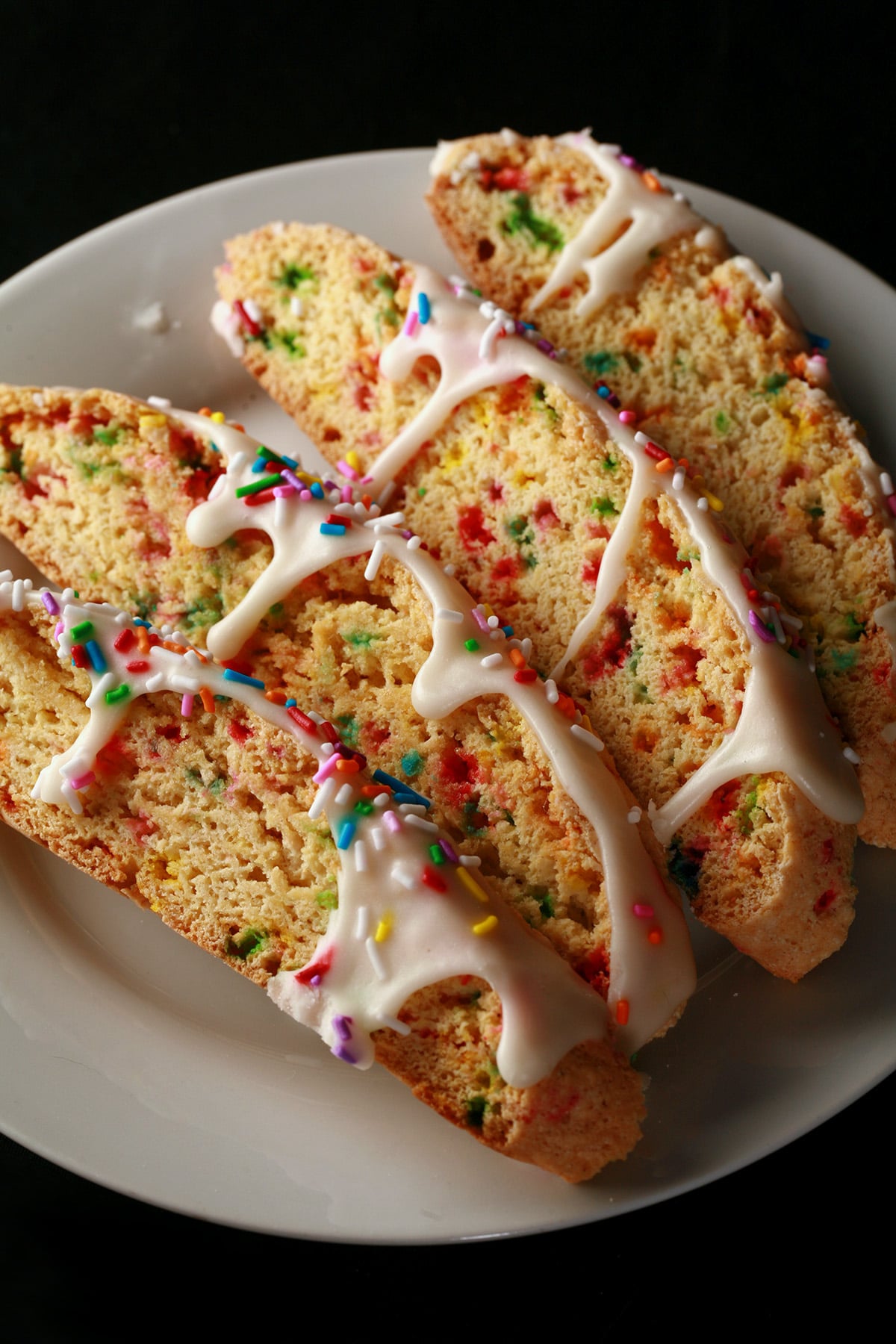 Several birthday cake biscotti on a plate.