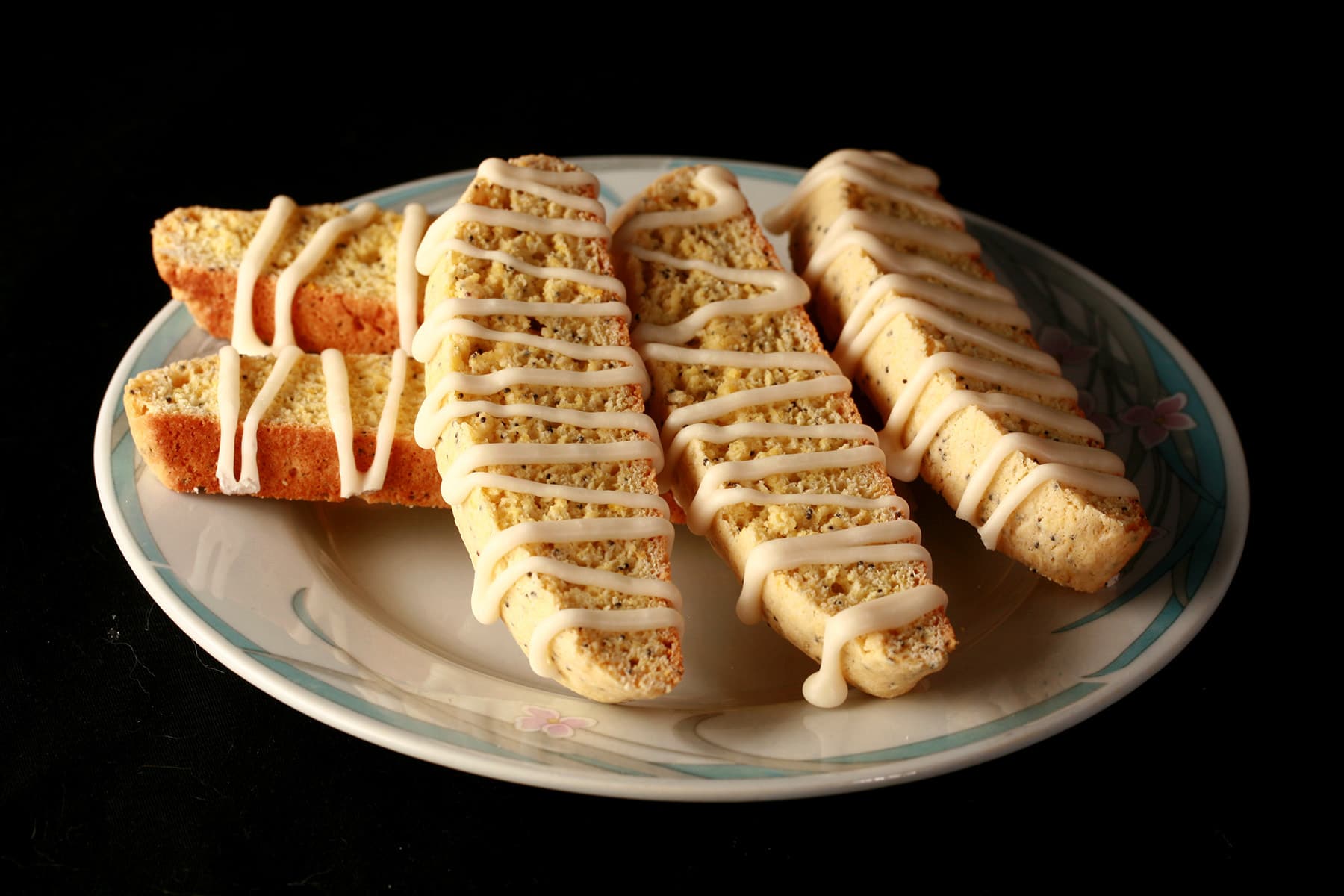 Several lemon poppyseed biscotti on a plate.