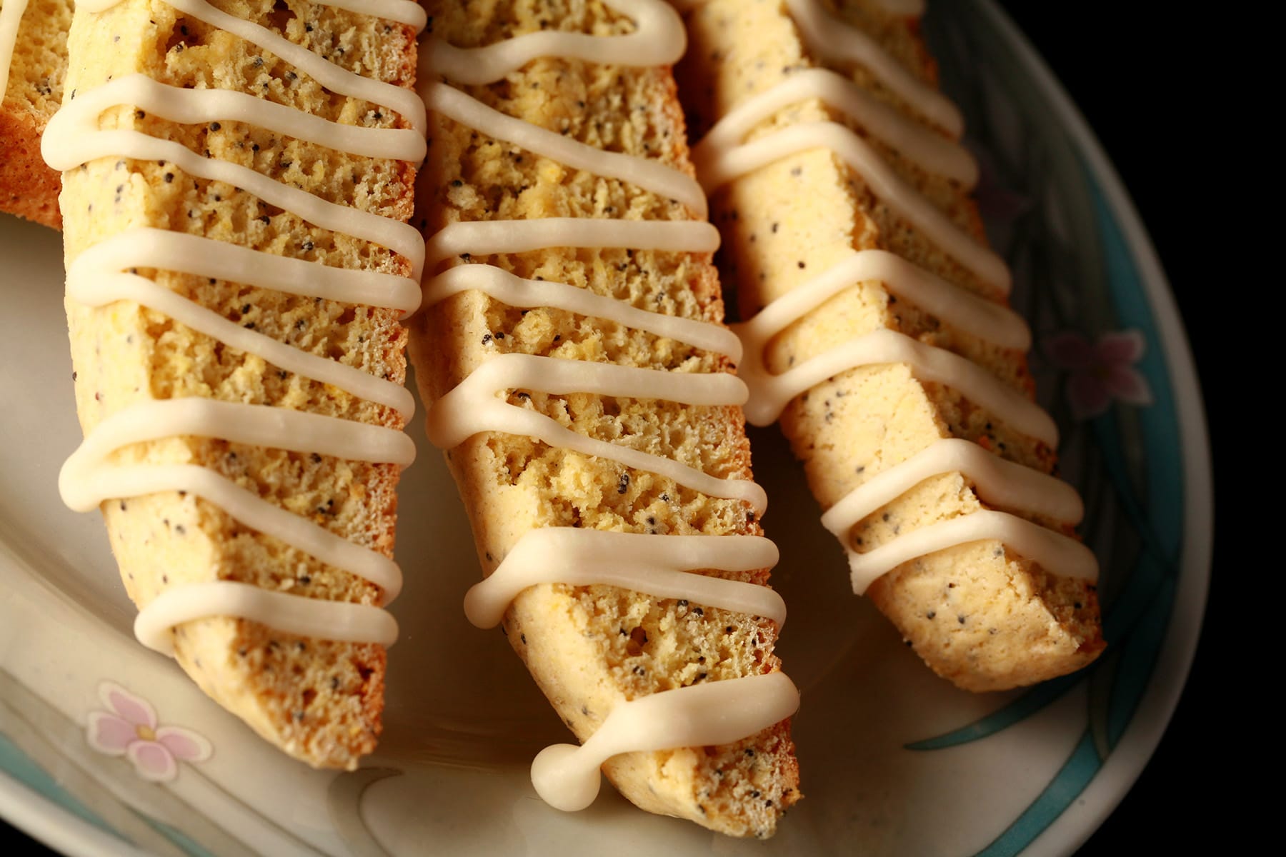 Several lemon poppyseed biscotti on a plate.