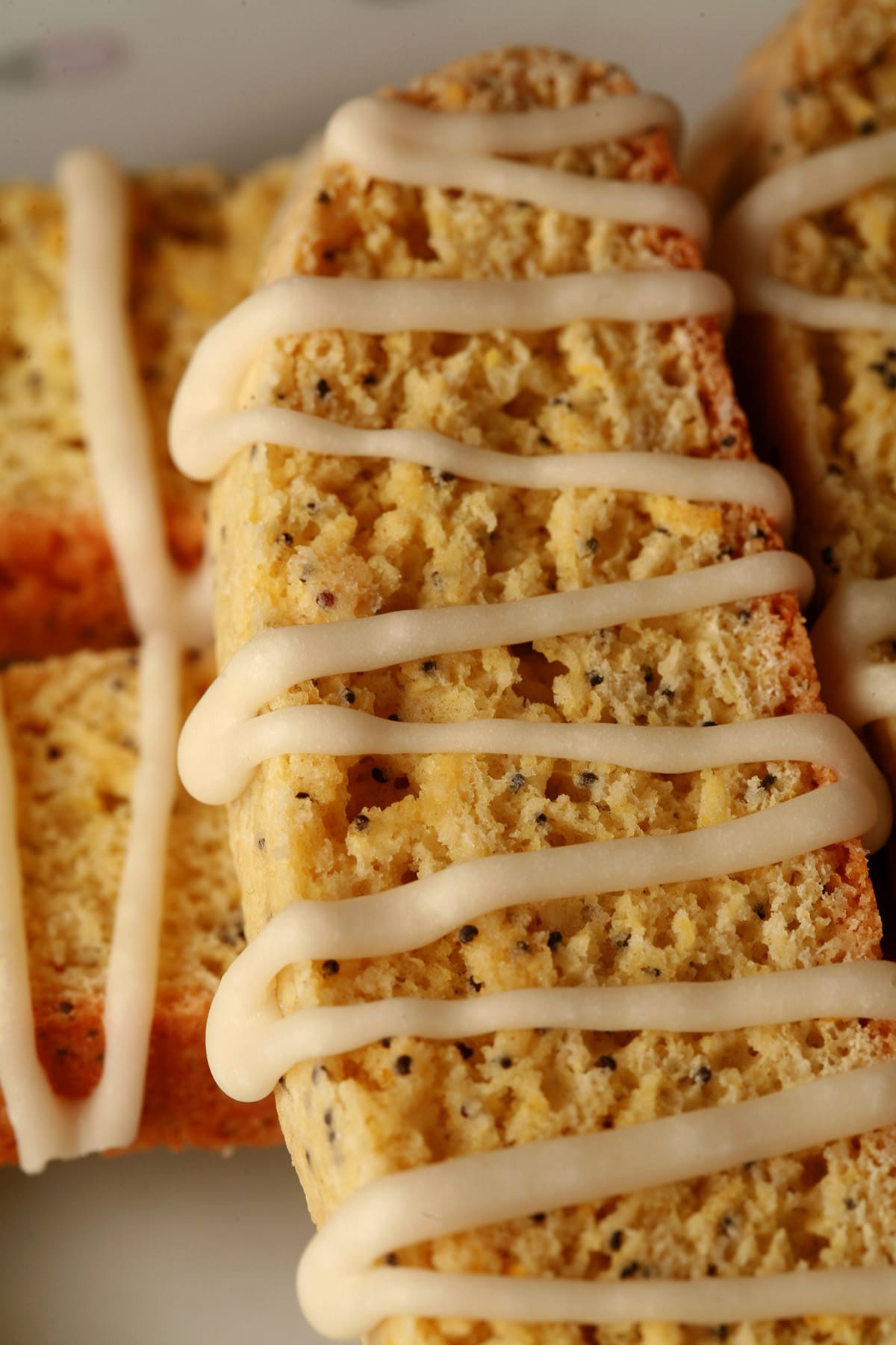 Several lemon poppy seed biscotti on a plate.