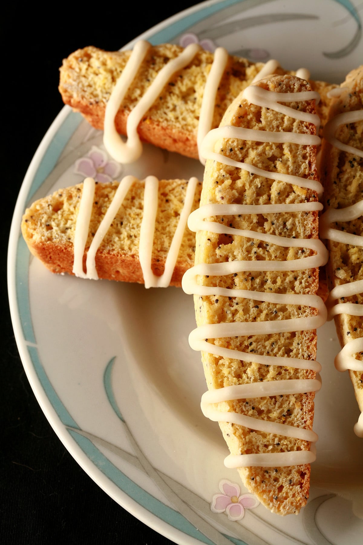 Several lemon poppy seed biscotti on a plate.