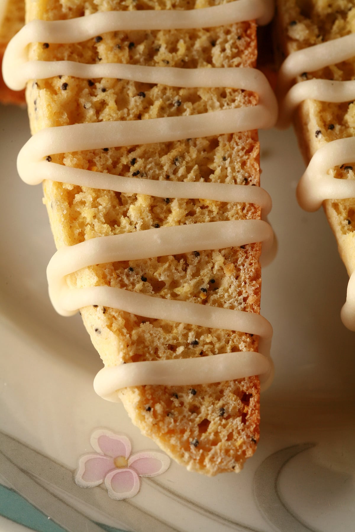 Several lemon poppy seed biscotti on a plate.