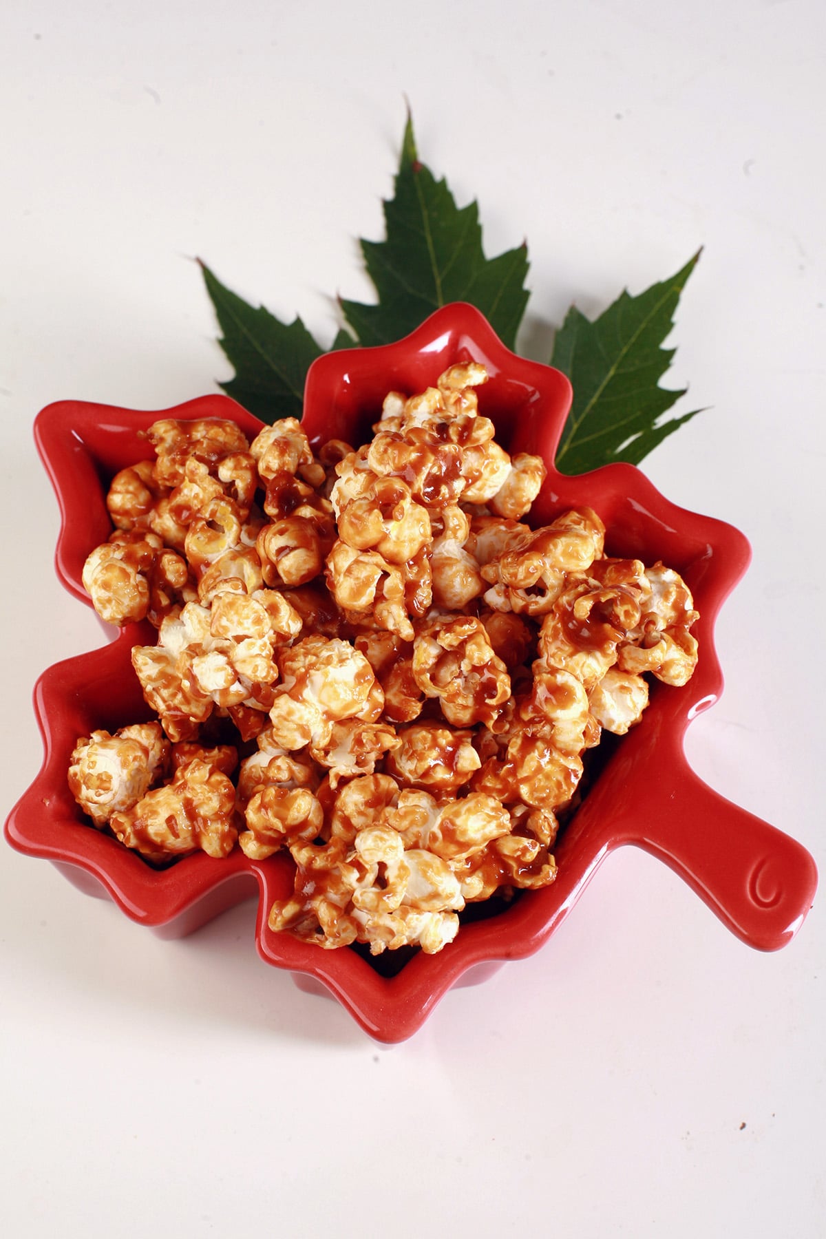 A maple leaf shaped bowl of maple popcorn.