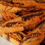 A plate of orange and black marbled biscotti.