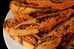 A plate of orange and black marbled biscotti.