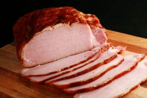 A sliced loin of smoked Canadian bacon.