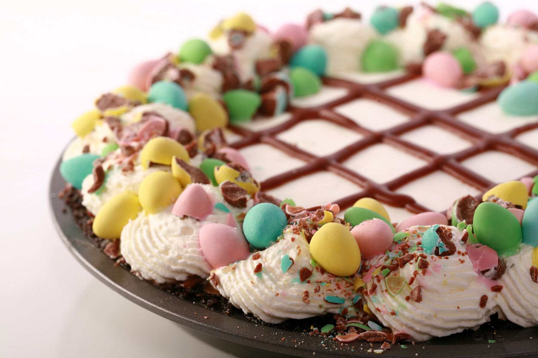 An Easter no bake chocolate cream pie with whipped cream and Cadbury Mini Eggs.