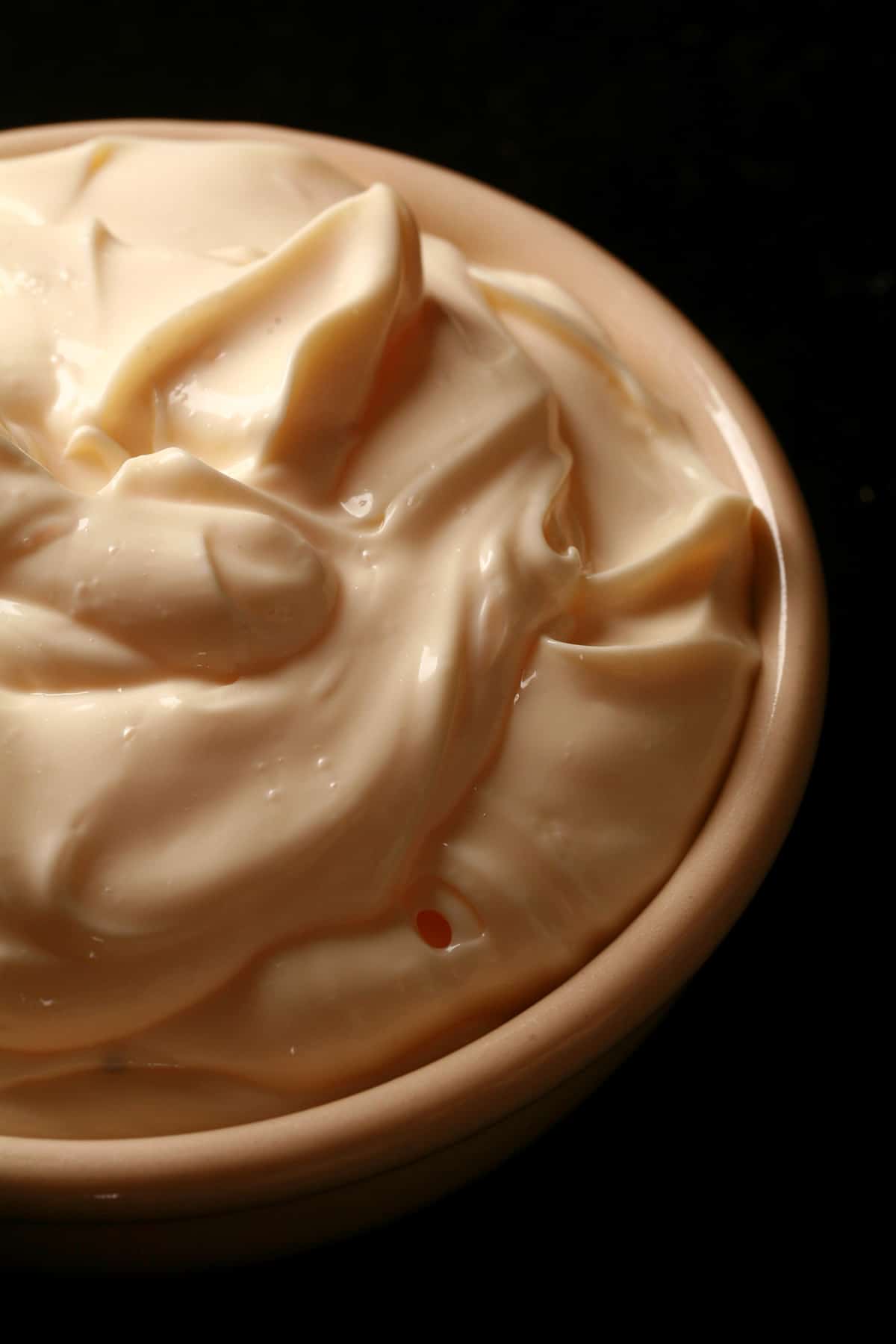 A close up view of a bowl of cold smoked mayonnaise.