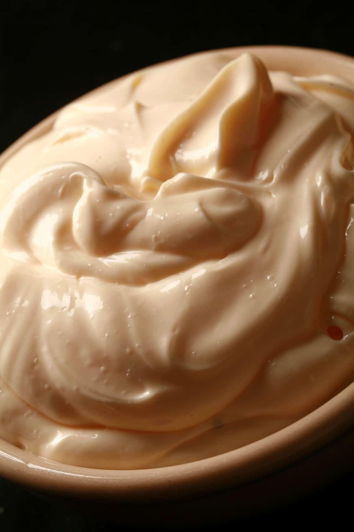 A close up view of a bowl of cold smoked mayo.