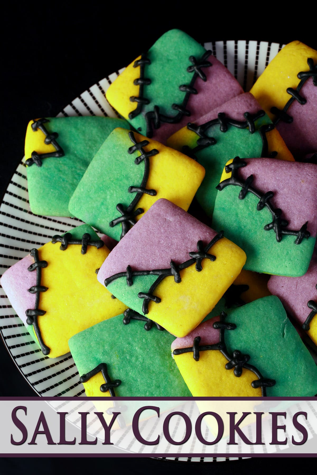 A plate of Sally cookies - random patches of purple, teal, and yellow cookie dough with frosting stitches.