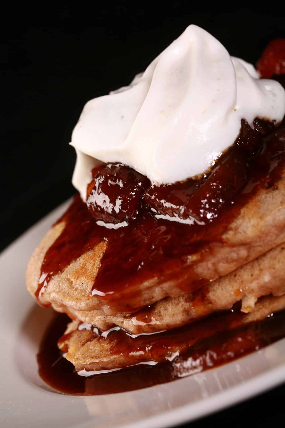 A stack of apple pancakes topped with caramel apple sauce.