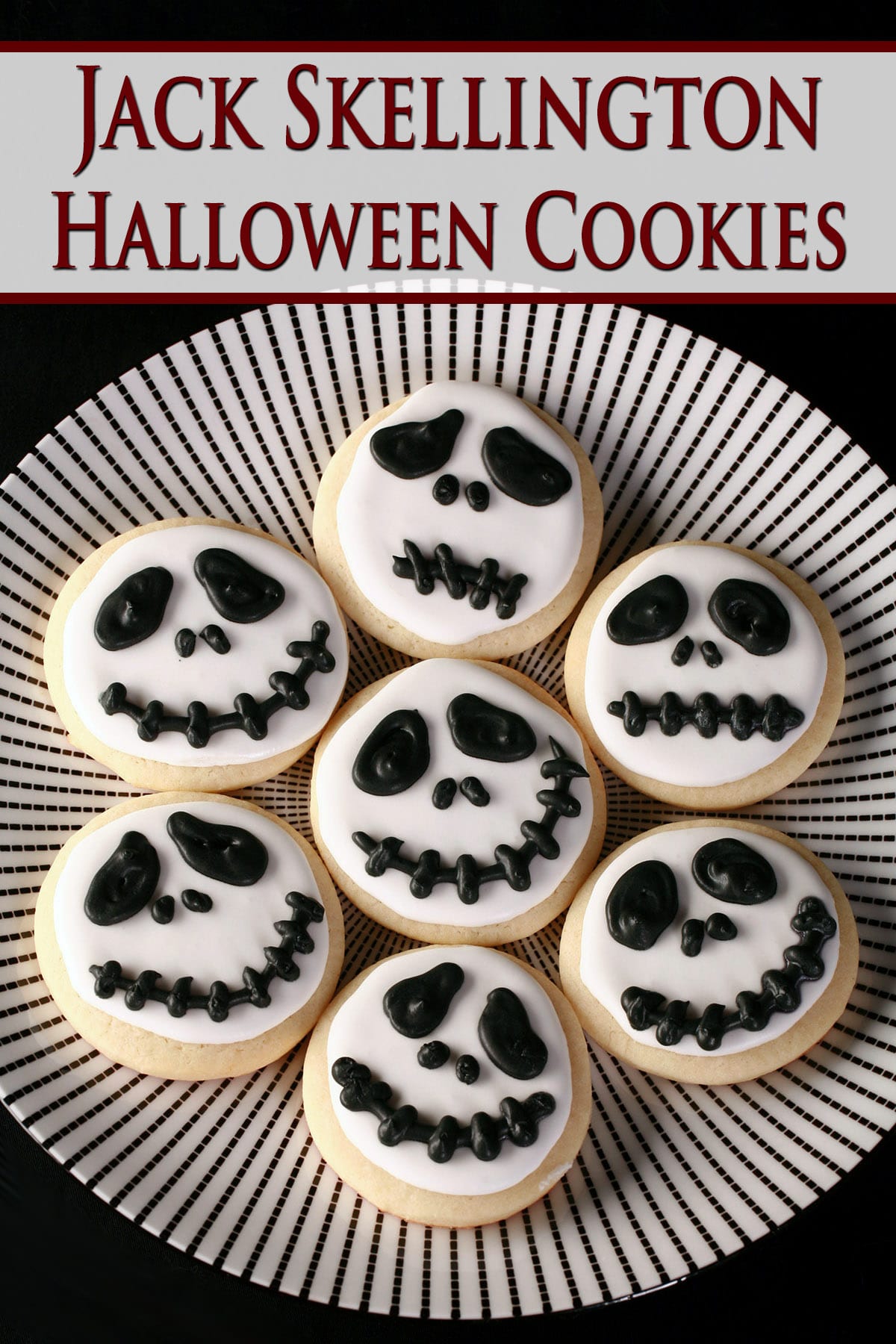 A plate of round white cookies with skeleton faces piped on them - Jack Skellington cookies.