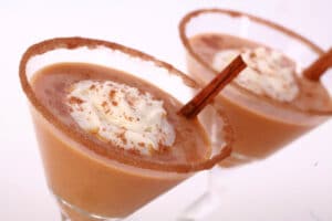 2 Pumpkin Pie Martinis with spiced sugar rim and whipped cream.