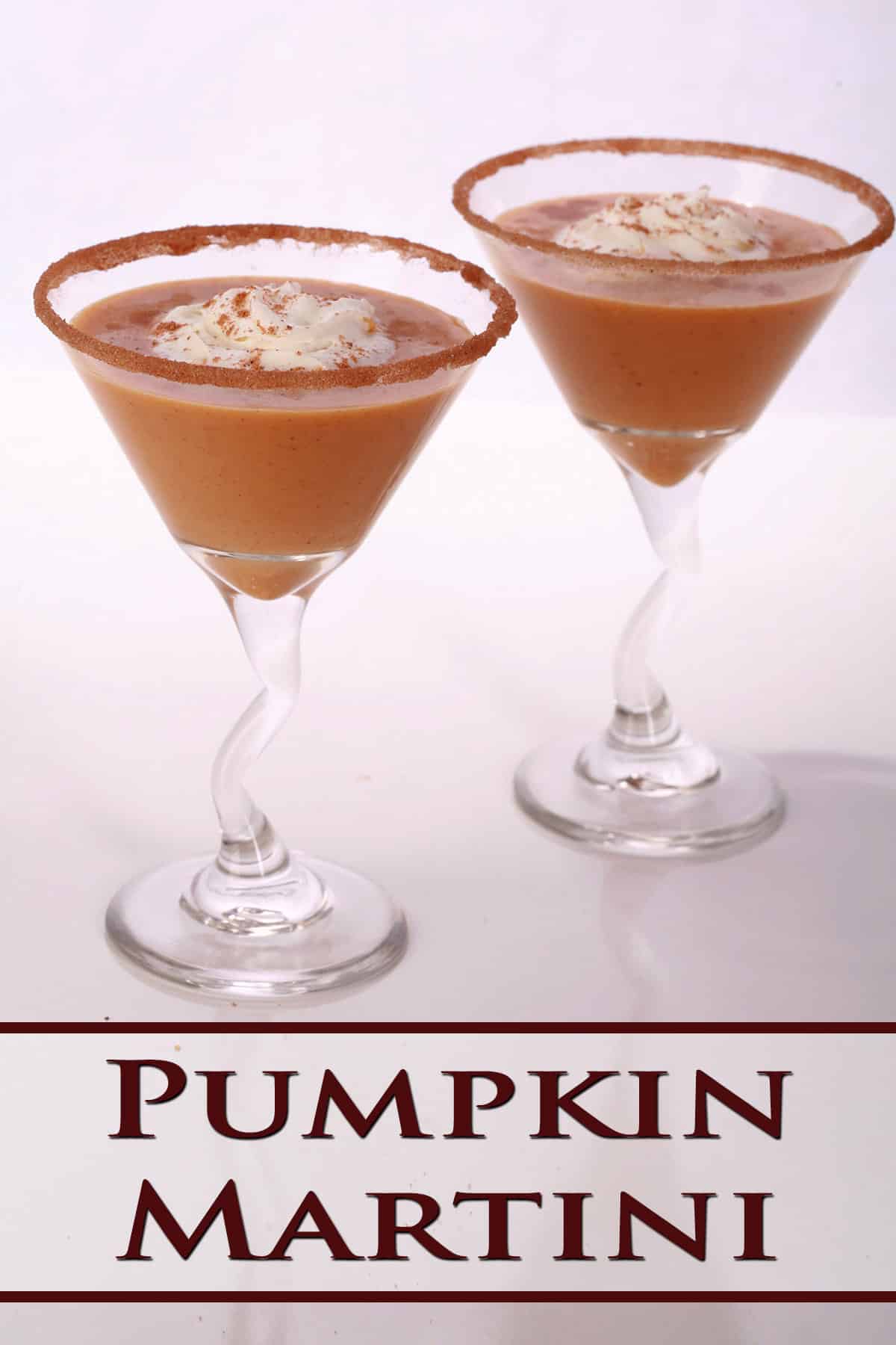 2 Pumpkin Pie Martini cocktails with spiced sugar rim and whipped cream.