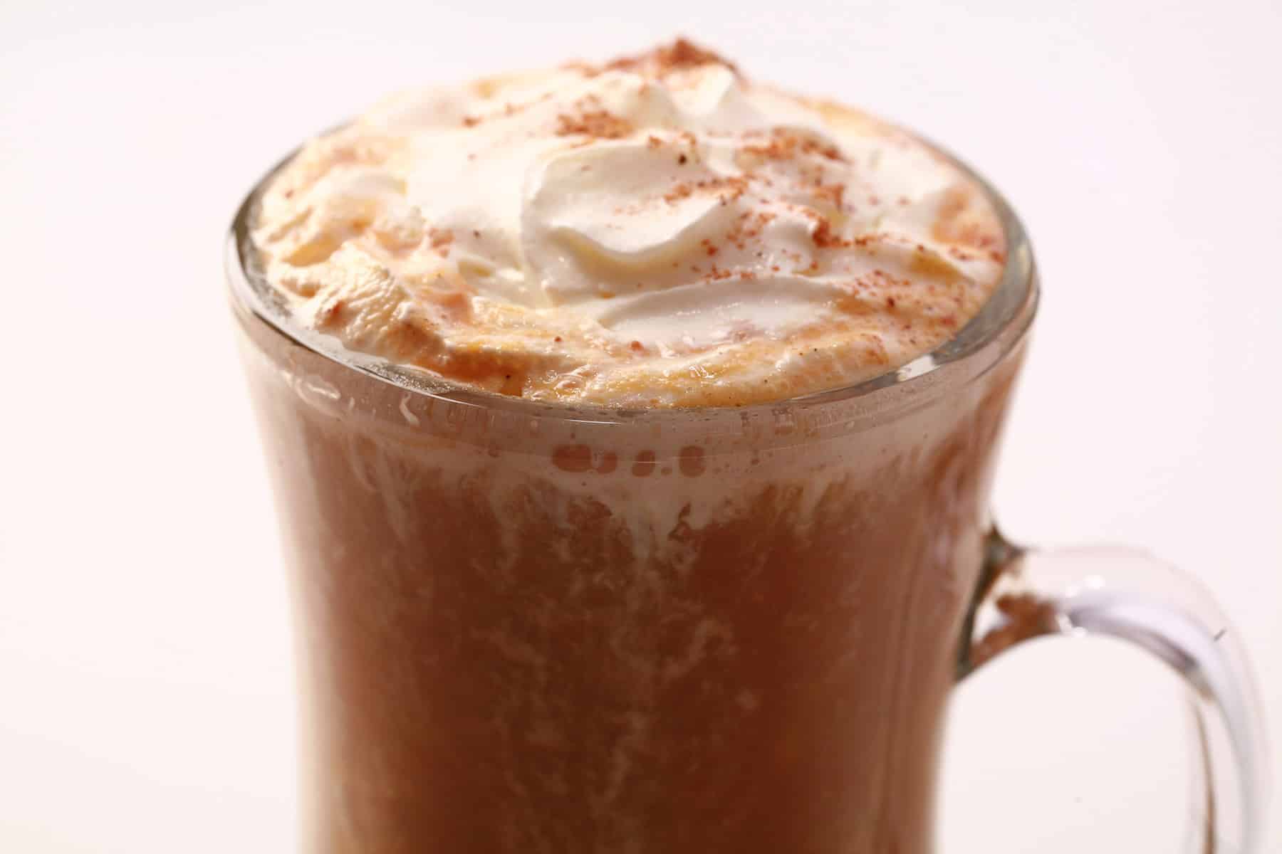 A homemade pumpkin spice latte, topped with whipped cream and nutmeg.