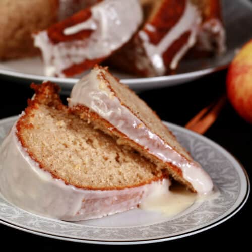2 slices of apple cider cake on a plate.