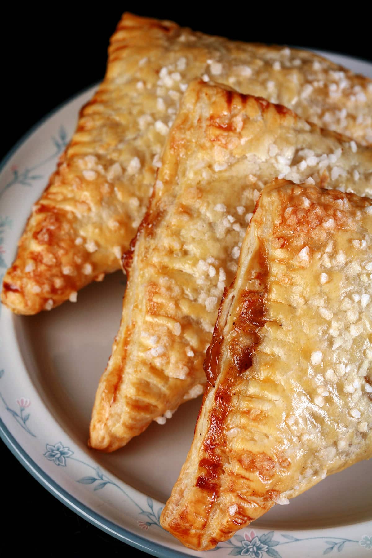 A plate of sugar crusted homemade apple turnovers.