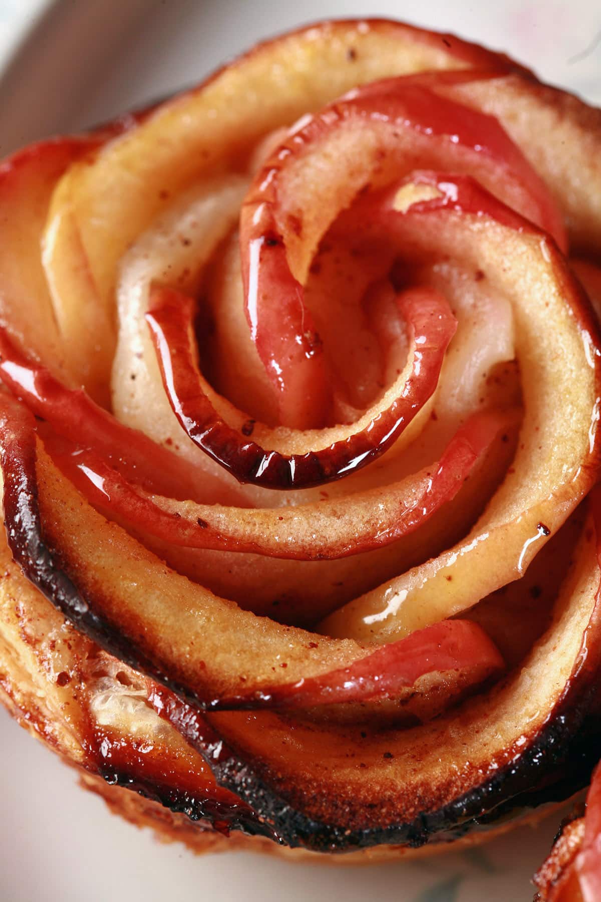 A close up view of an apple rose pastry.