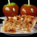 A slice of maple caramel apple pie in front of two maple caramel apples.