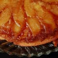 A close up view of a whole uncut apple upside down cake.