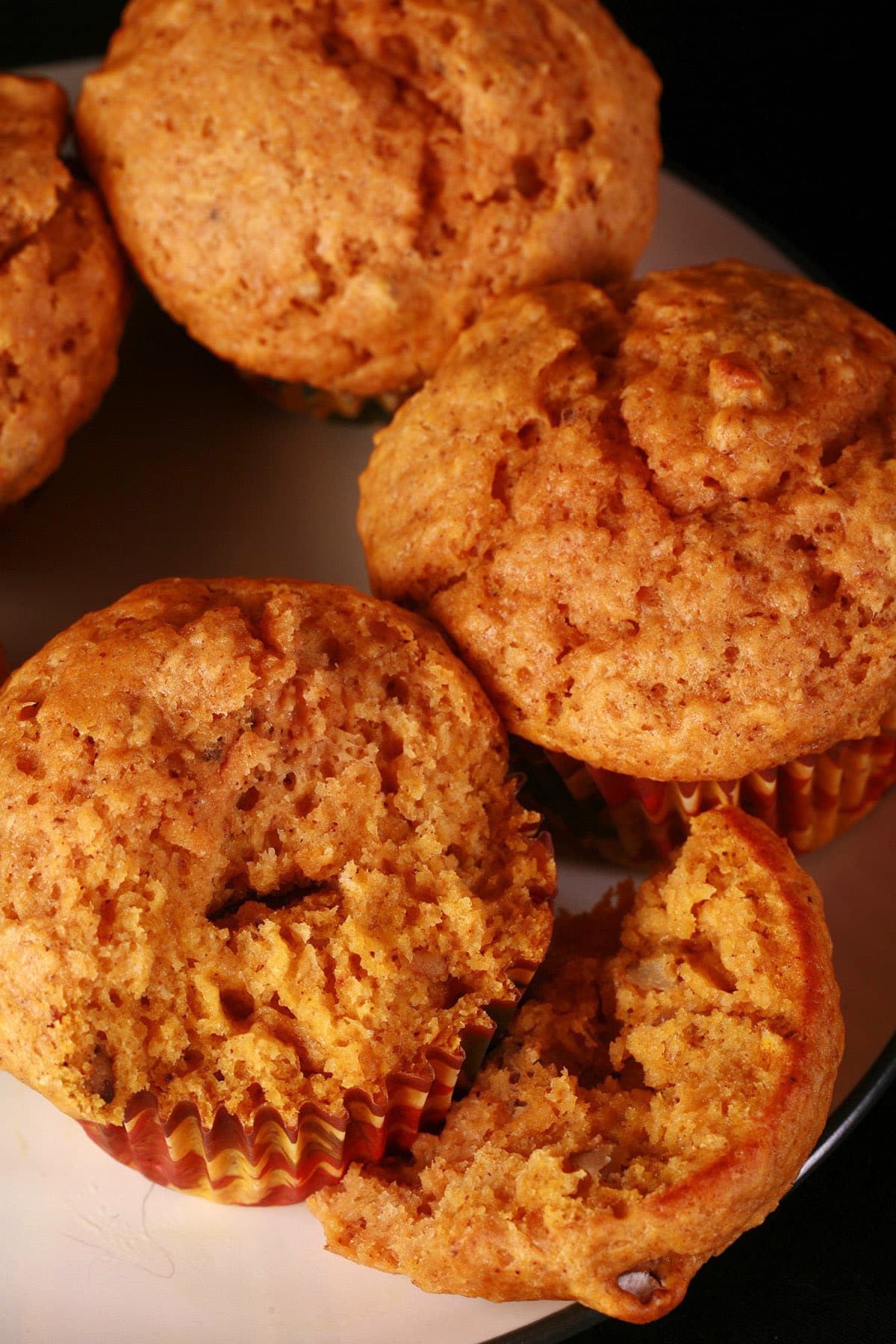 Several pumpkin spice muffins on a plate.