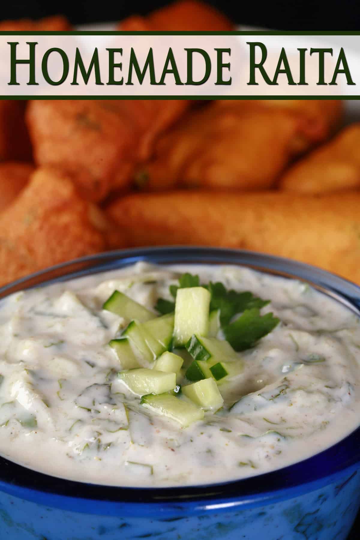A bowl of cucumber raita in front of a plate of pakoras.