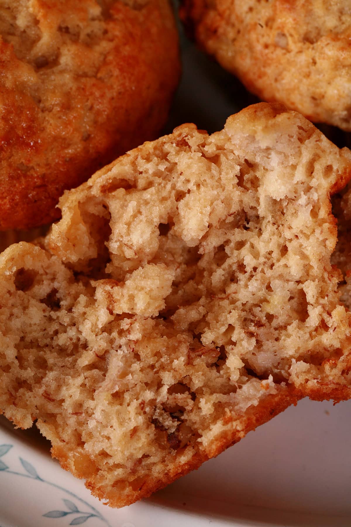 A close up view of half of a banana nut muffin.