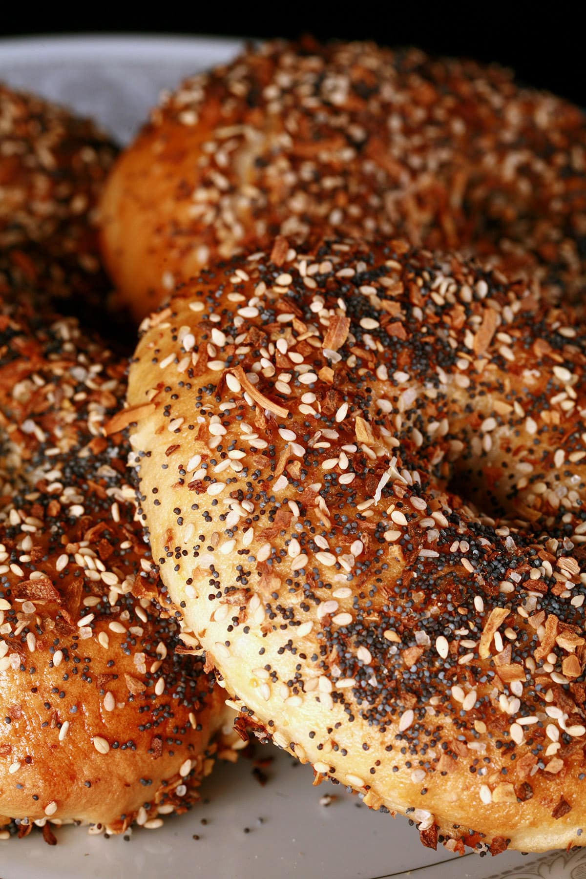 A plate of homemade everything seasoned bagels.