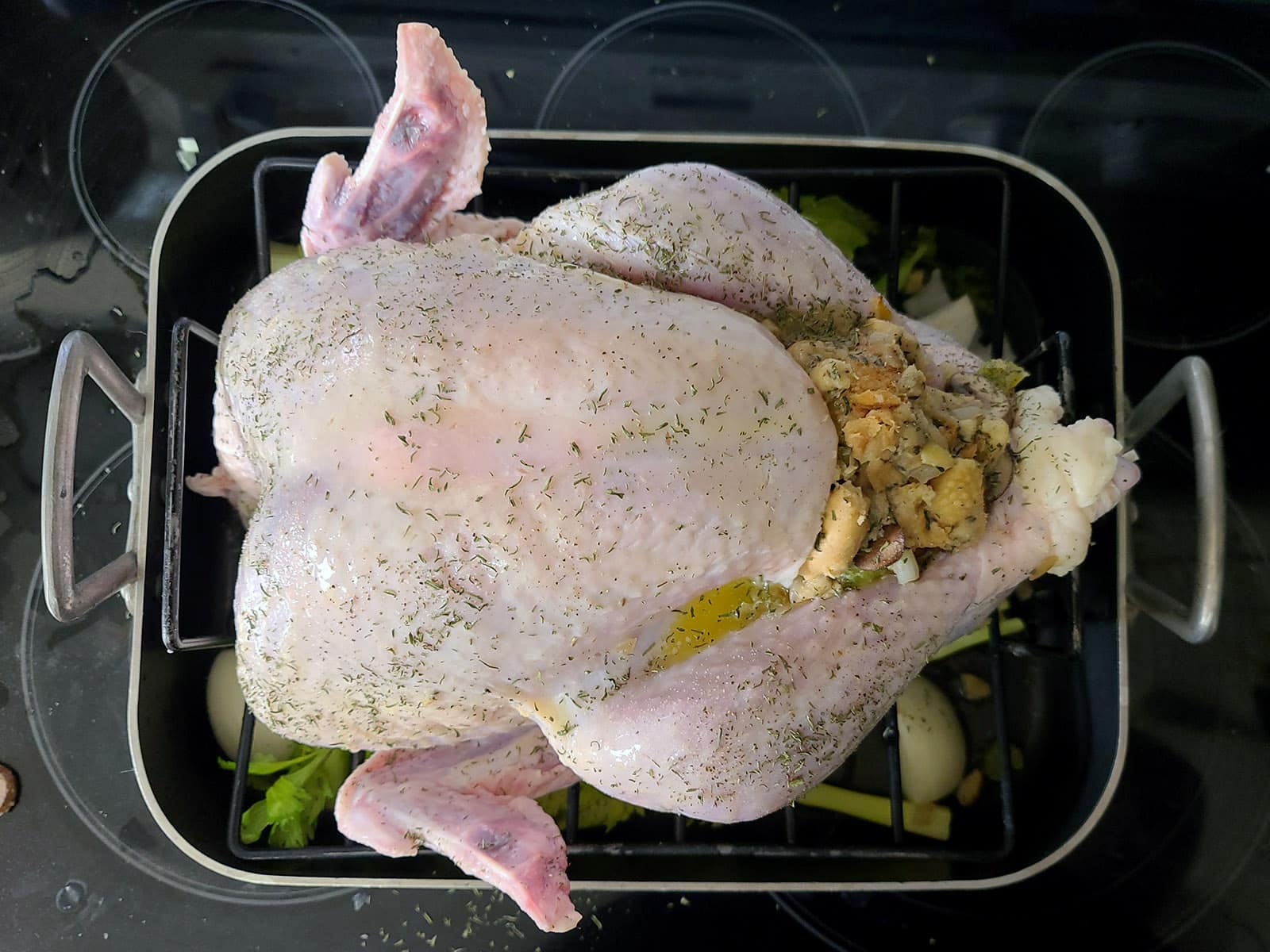 An overhead view of a stuffed roasted turkey before going in the oven.