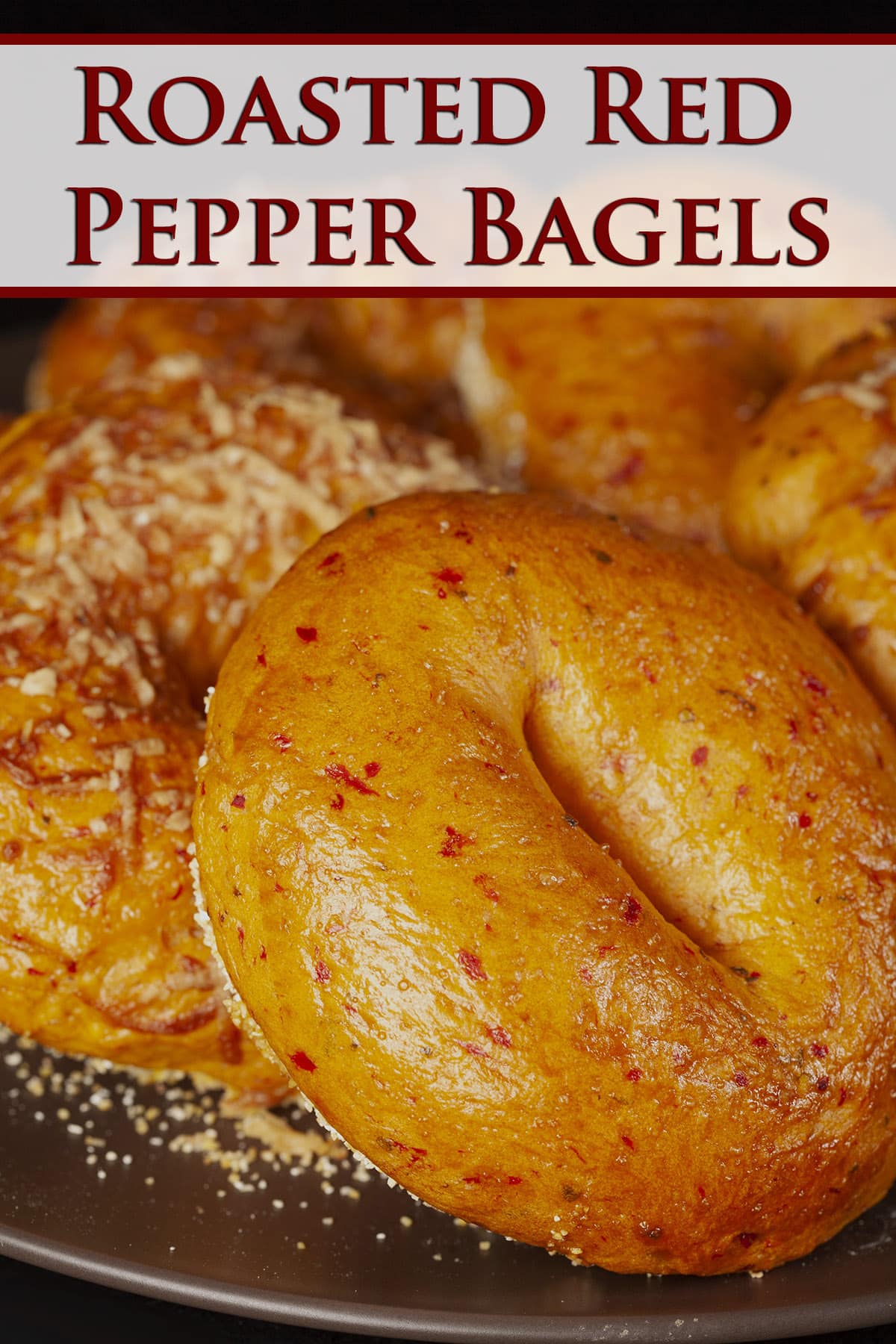 A plate of roasted red pepper bagels, some with Parmesan cheese on top.