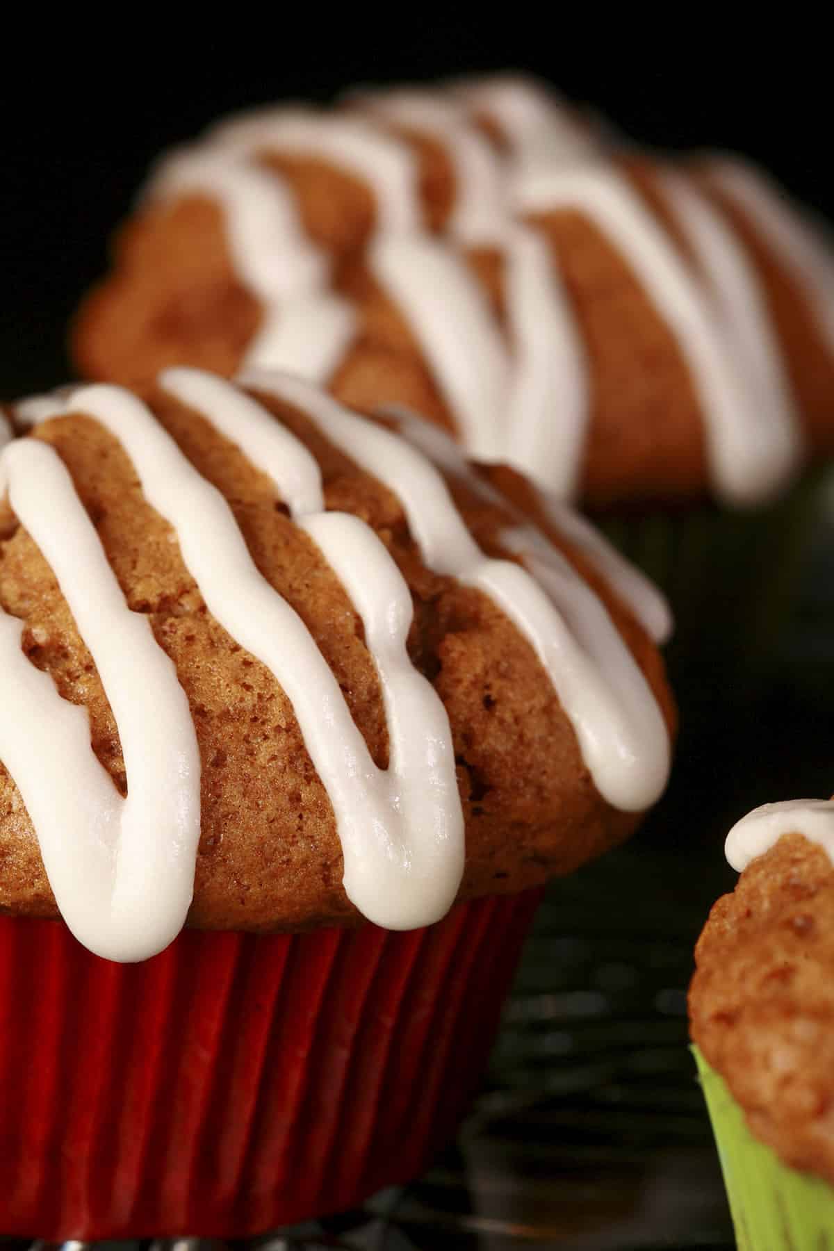 A plate of homemade gingerbread muffins, each drizzled with a white frosting.