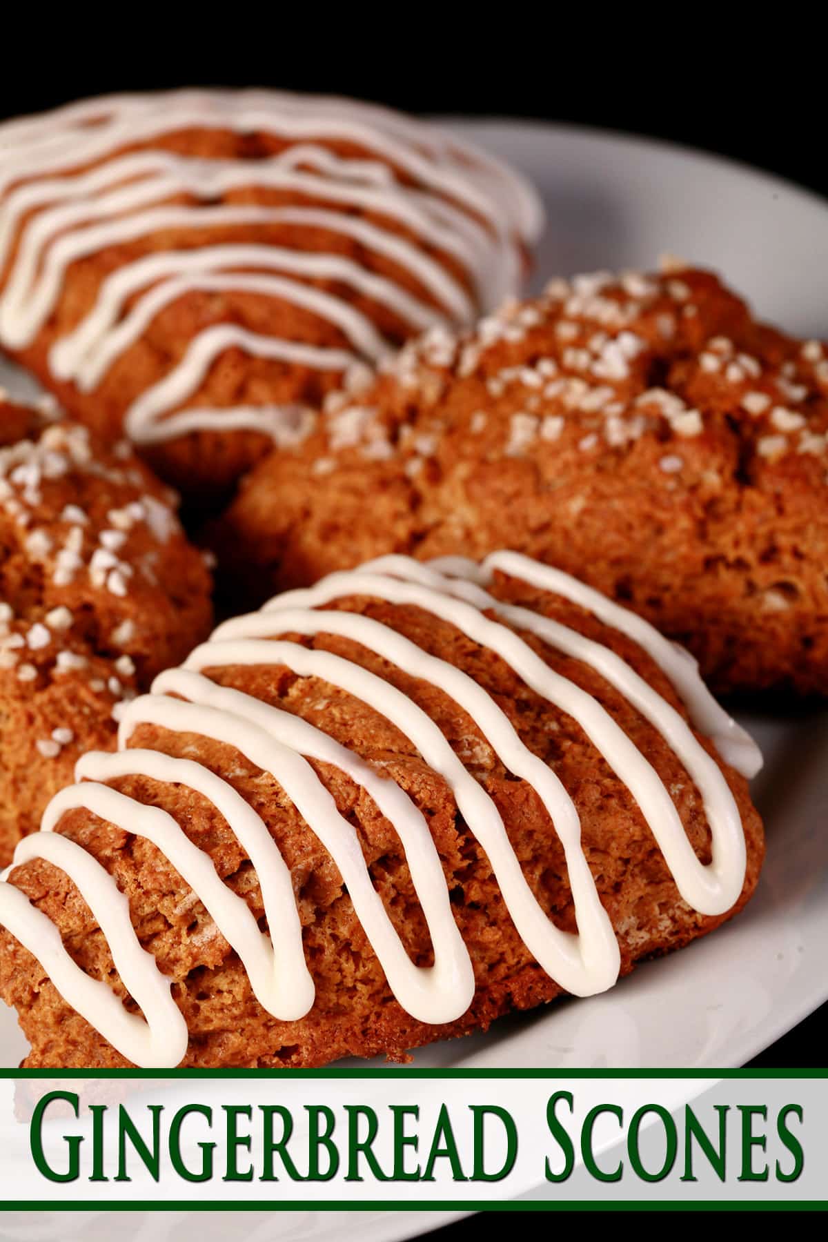 A plate of gingerbread scone wedges. Some have sugar topping, others are drizzled with glaze.