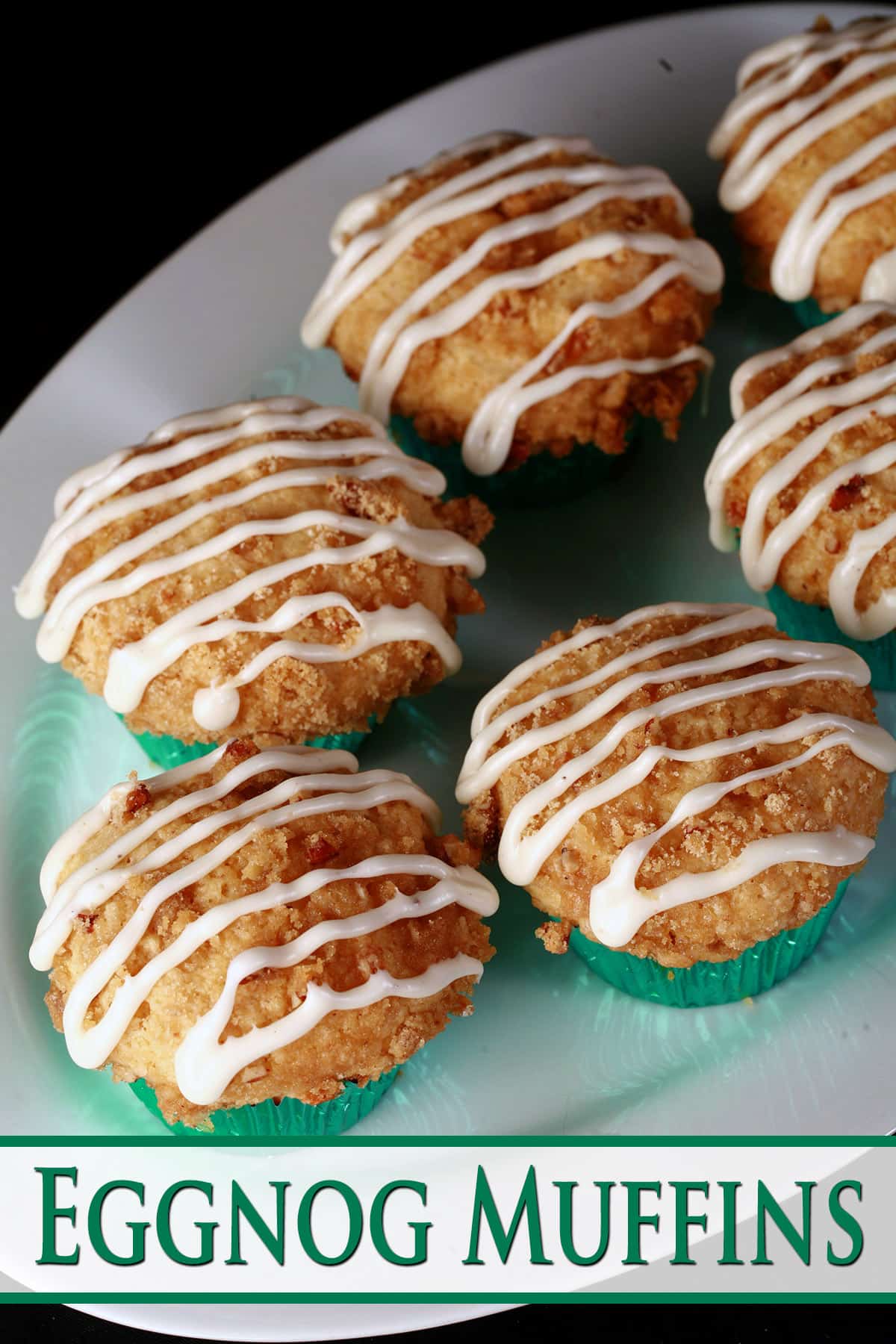 A plate of eggnog muffins, with pecan streusel and drizzled glaze.
