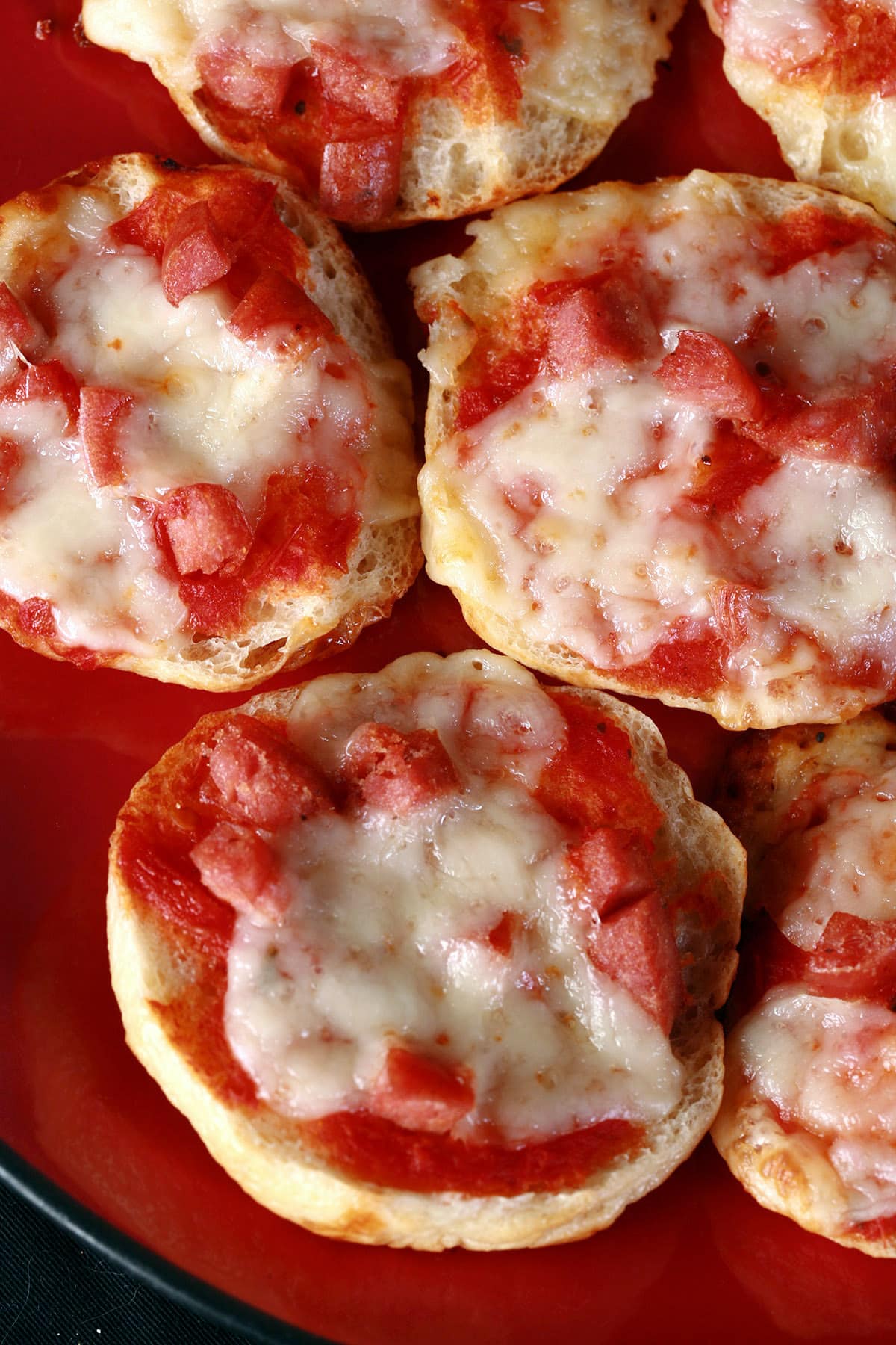 A plate of pepperoni and cheese homemade bagel bites pizza snacks.