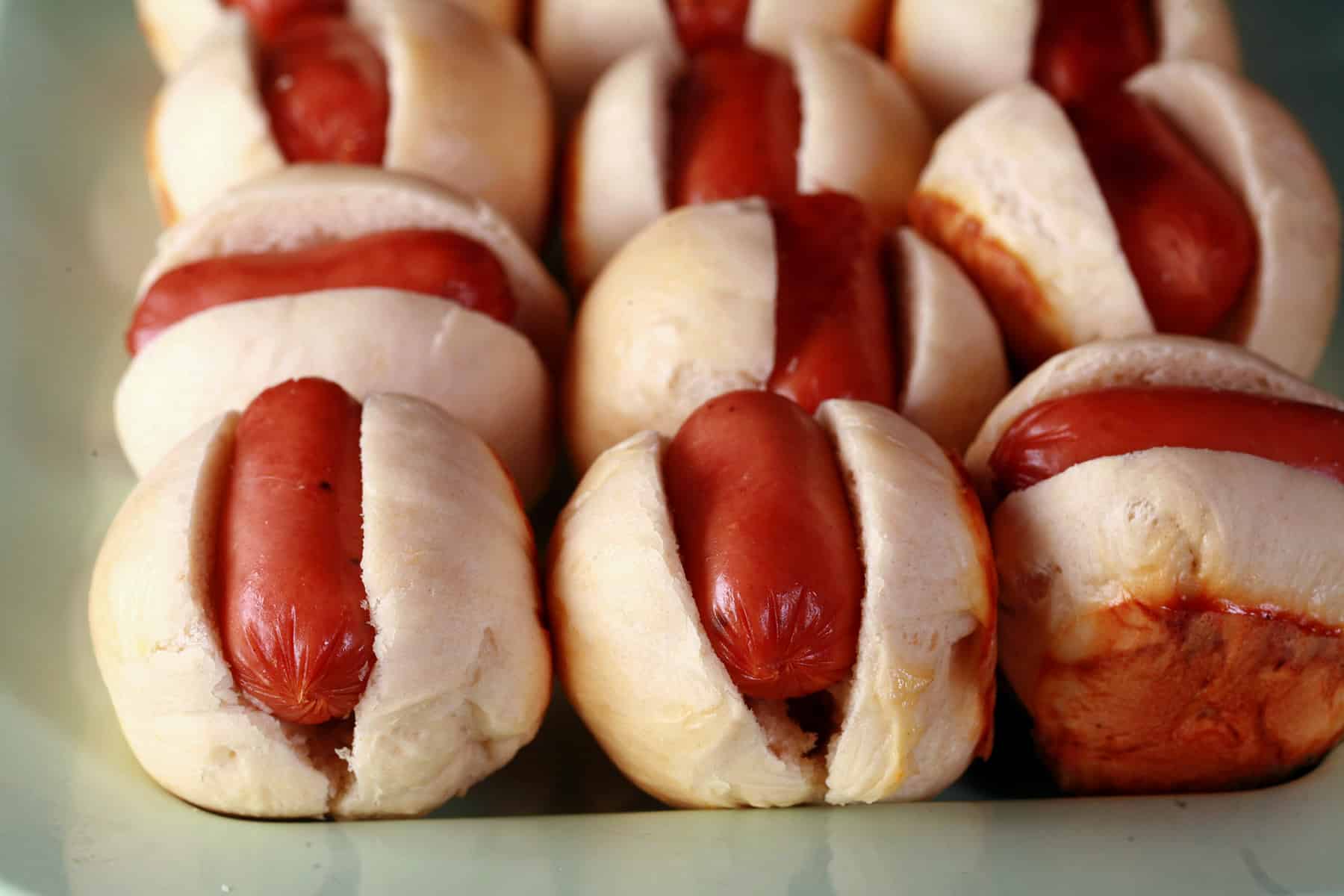 A plate of hot dog sliders.
