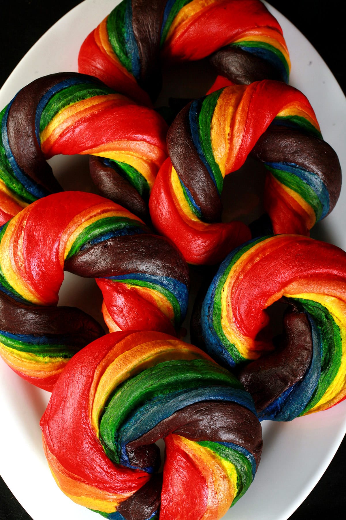 A platter of brightly coloured homemade rainbow bagels.