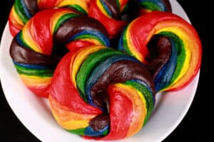 A platter of brightly coloured homemade rainbow bagels.