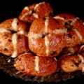 A pile of hot cross bagels on a plate.