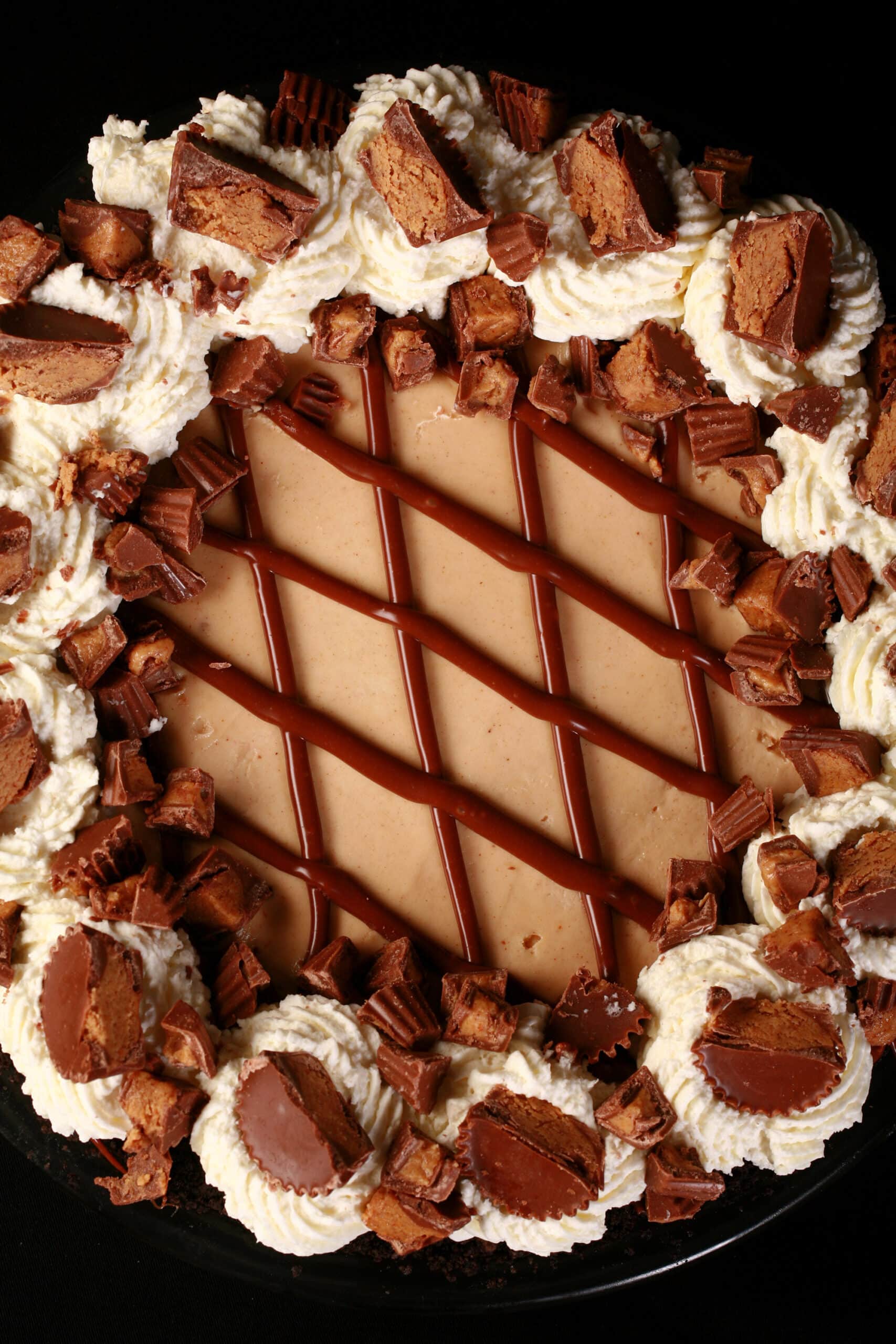 A whole Reese’s Pie, topped with chopped up mini peanut butter cups.