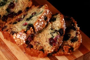 A sliced loaf of banana blueberry bread.