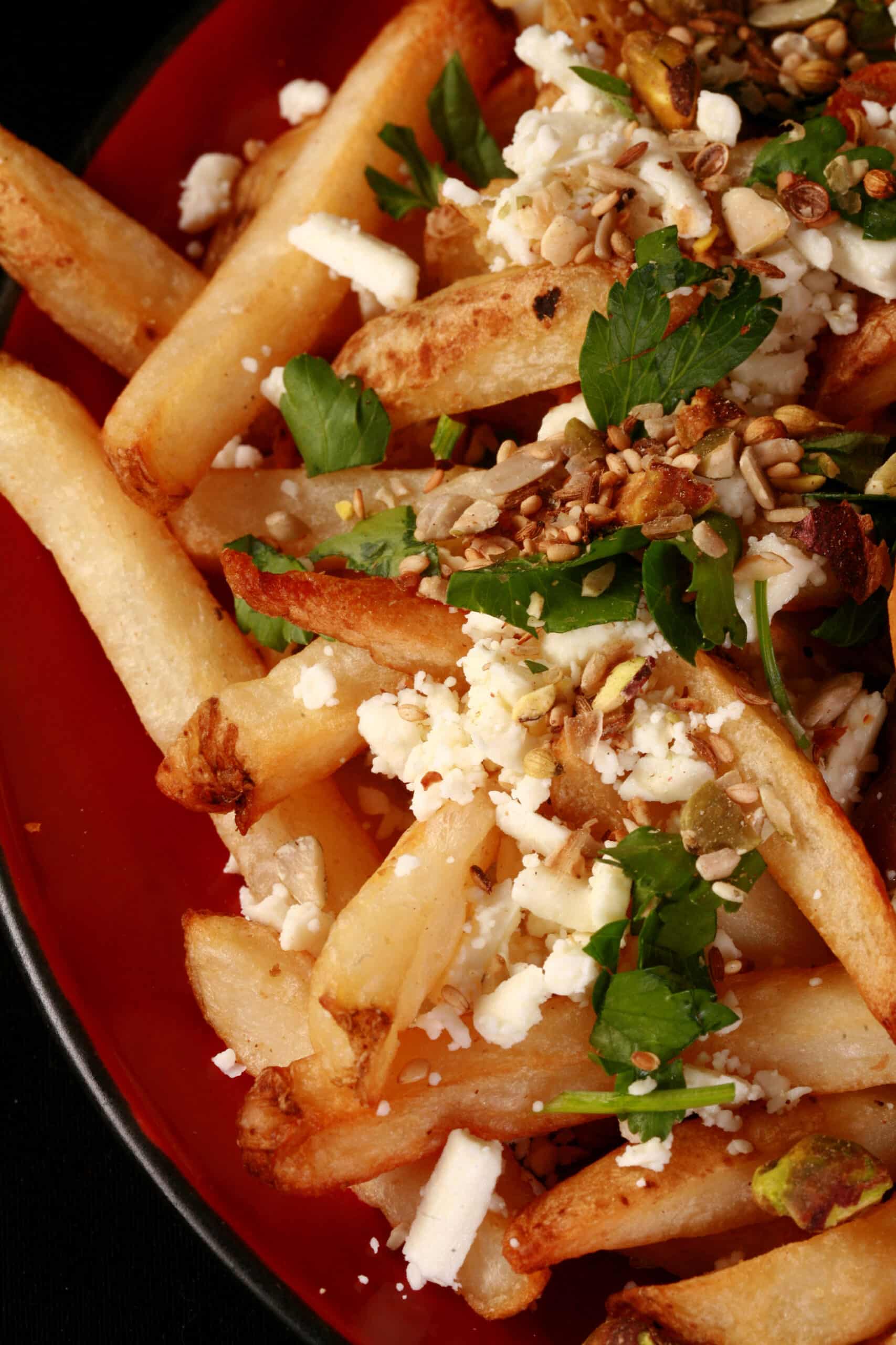 Fries with feta, dukkah, mint, and parsley