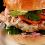 A close up view of a lemongrass chicken banh mi burger.