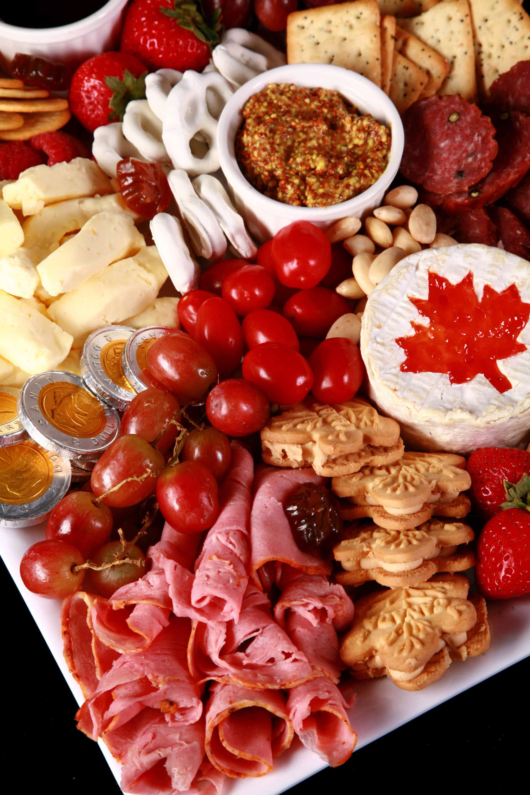 A red and white Canada themed charcuterie board.