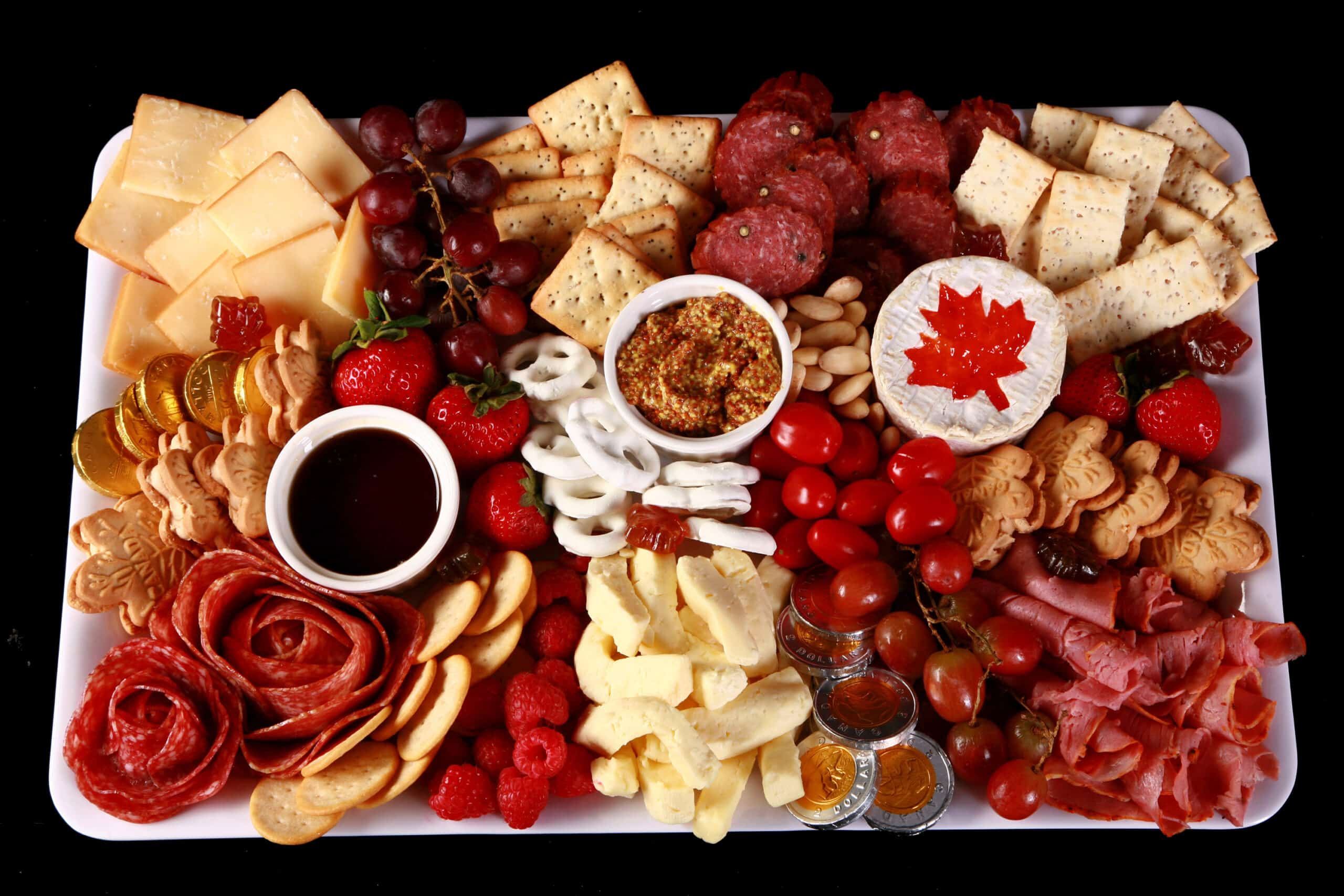 A red and white Canada themed charcuterie board.