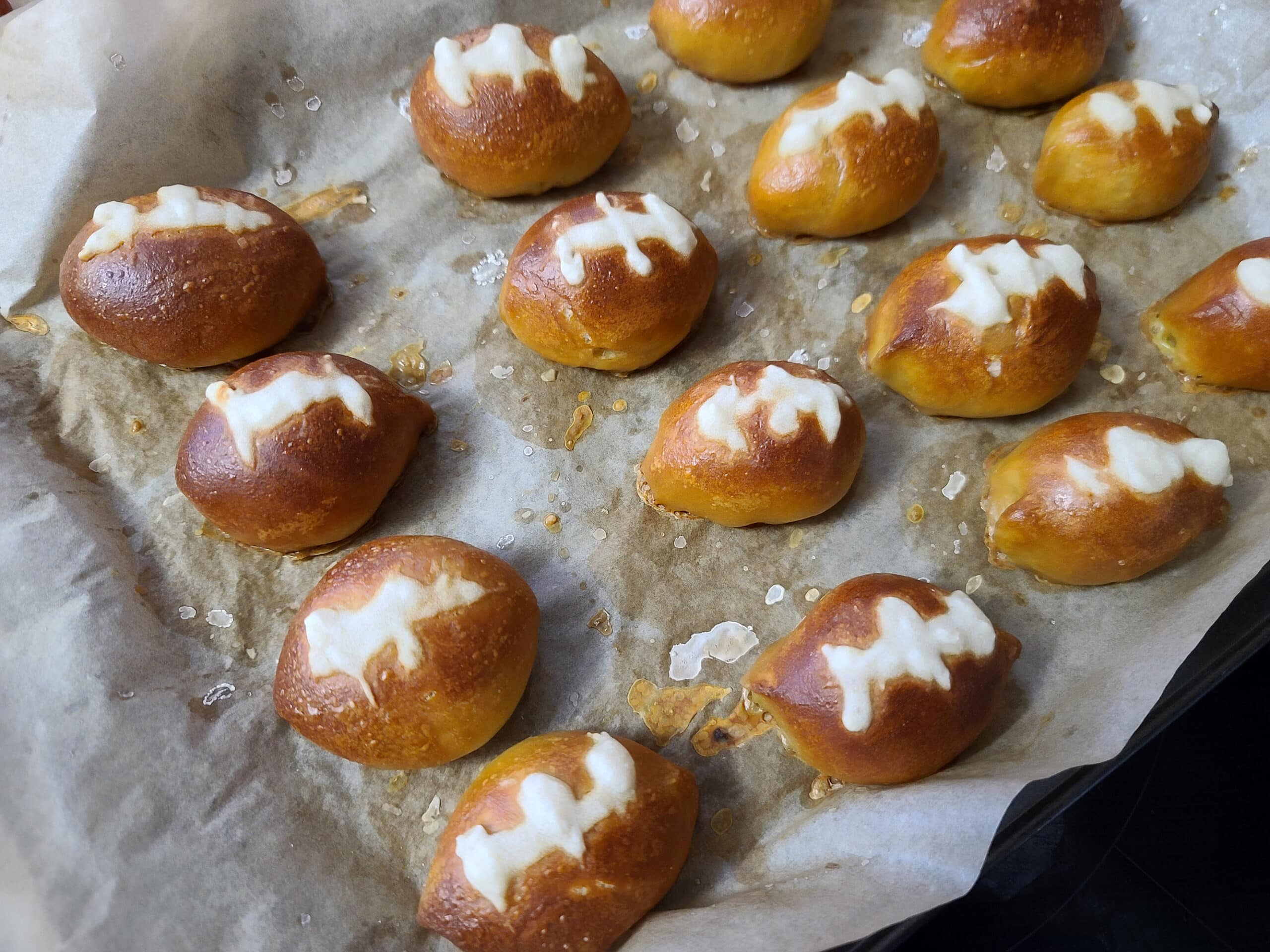 A plate of freshly baked football shaped pretzels.