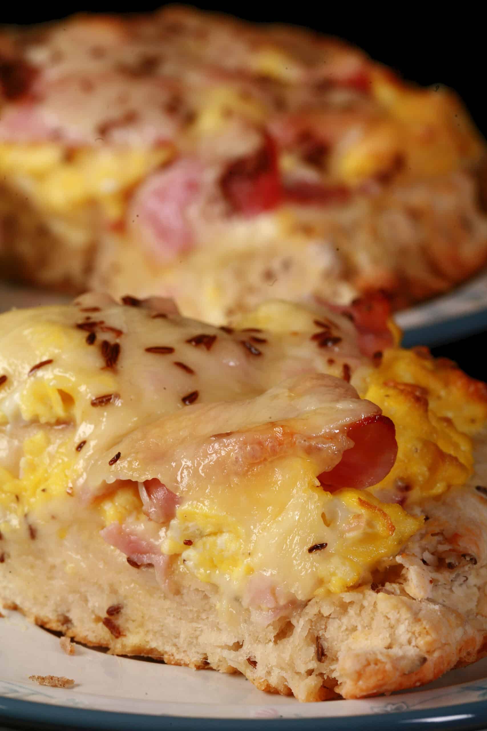 A ham and swiss breakfast pizza on a biscuit crust.