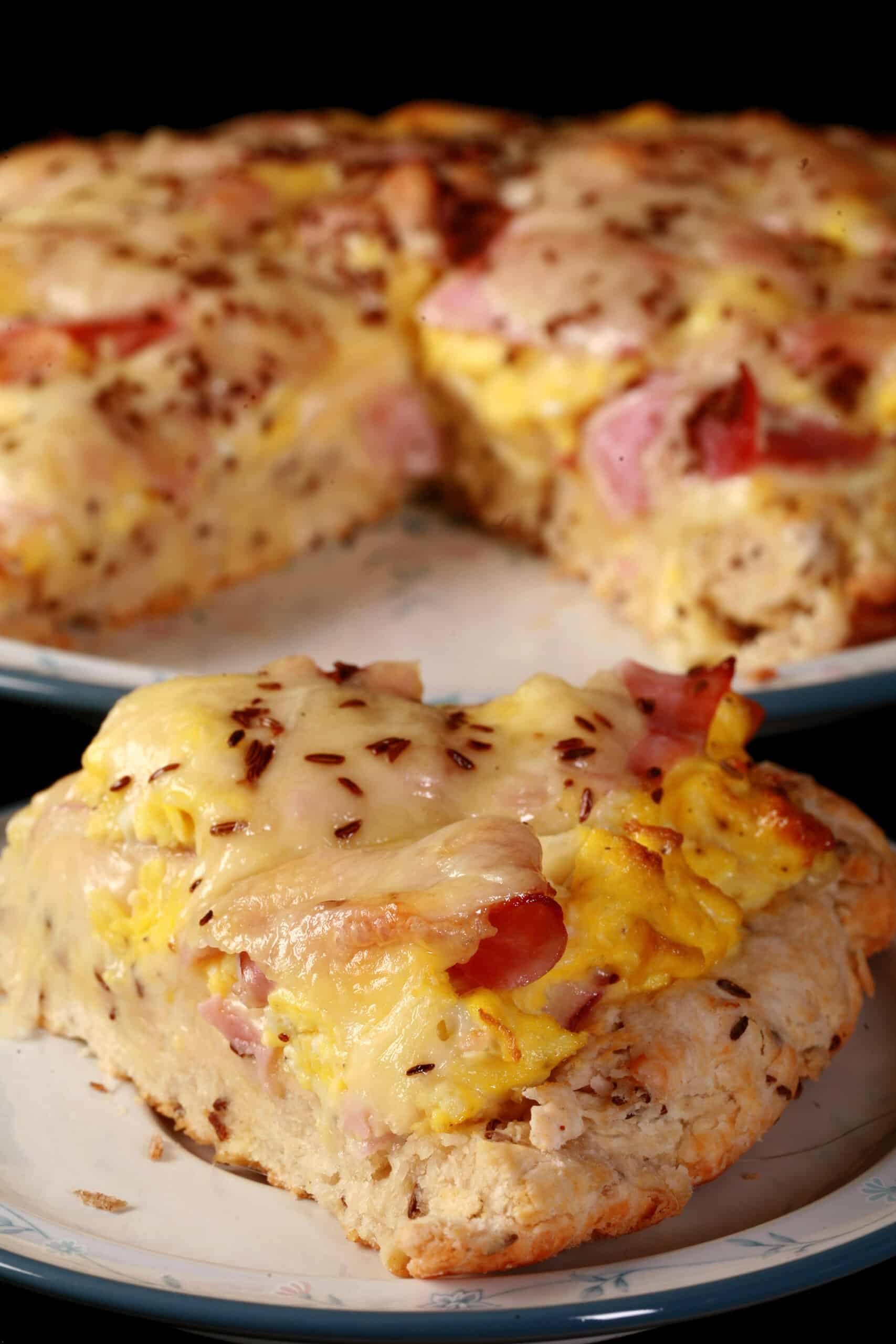 A ham and swiss breakfast pizza on a biscuit crust.