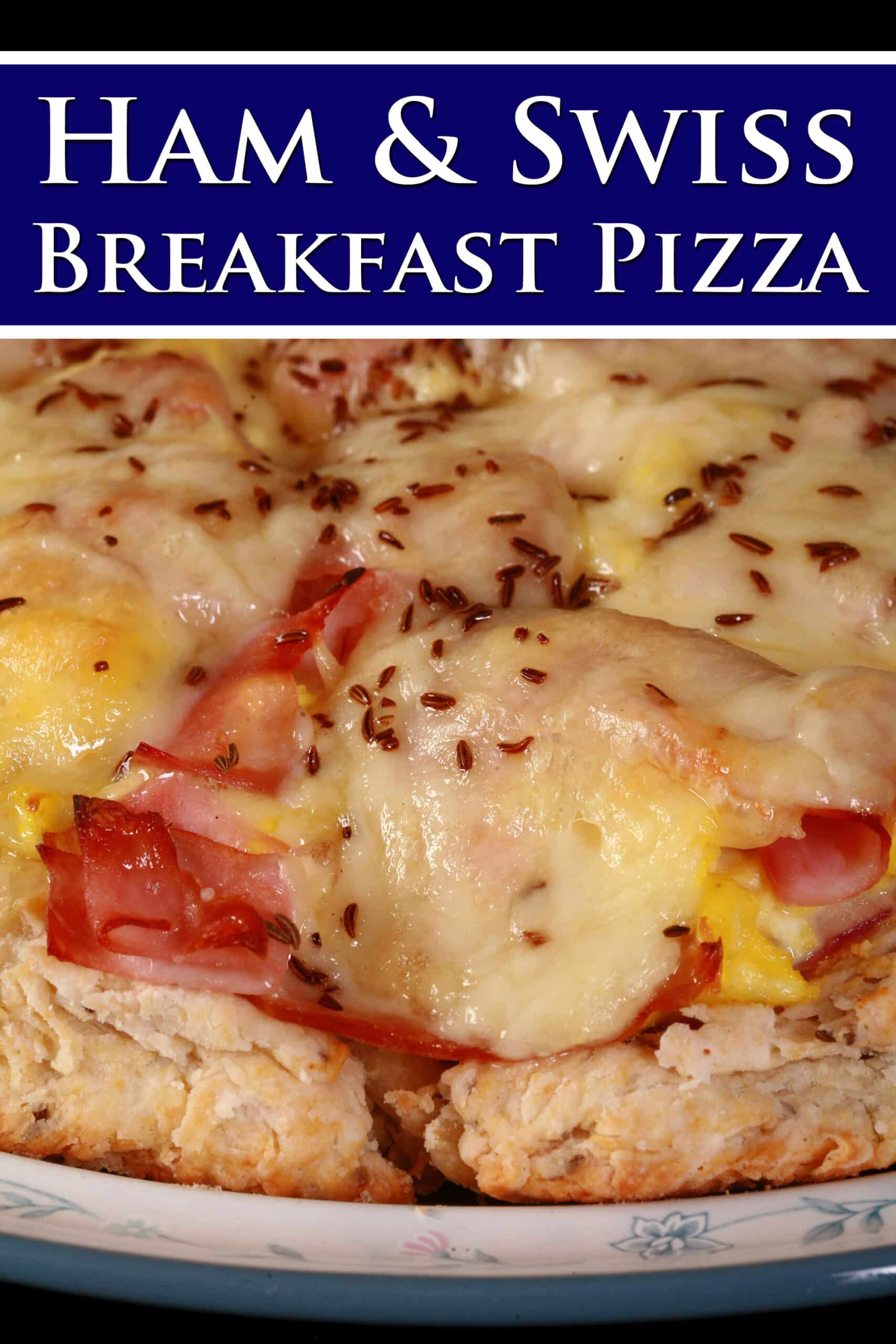 A ham and swiss cheese breakfast pizza on a biscuit crust.  Overlaid text says ham and swiss breakfast pizza.