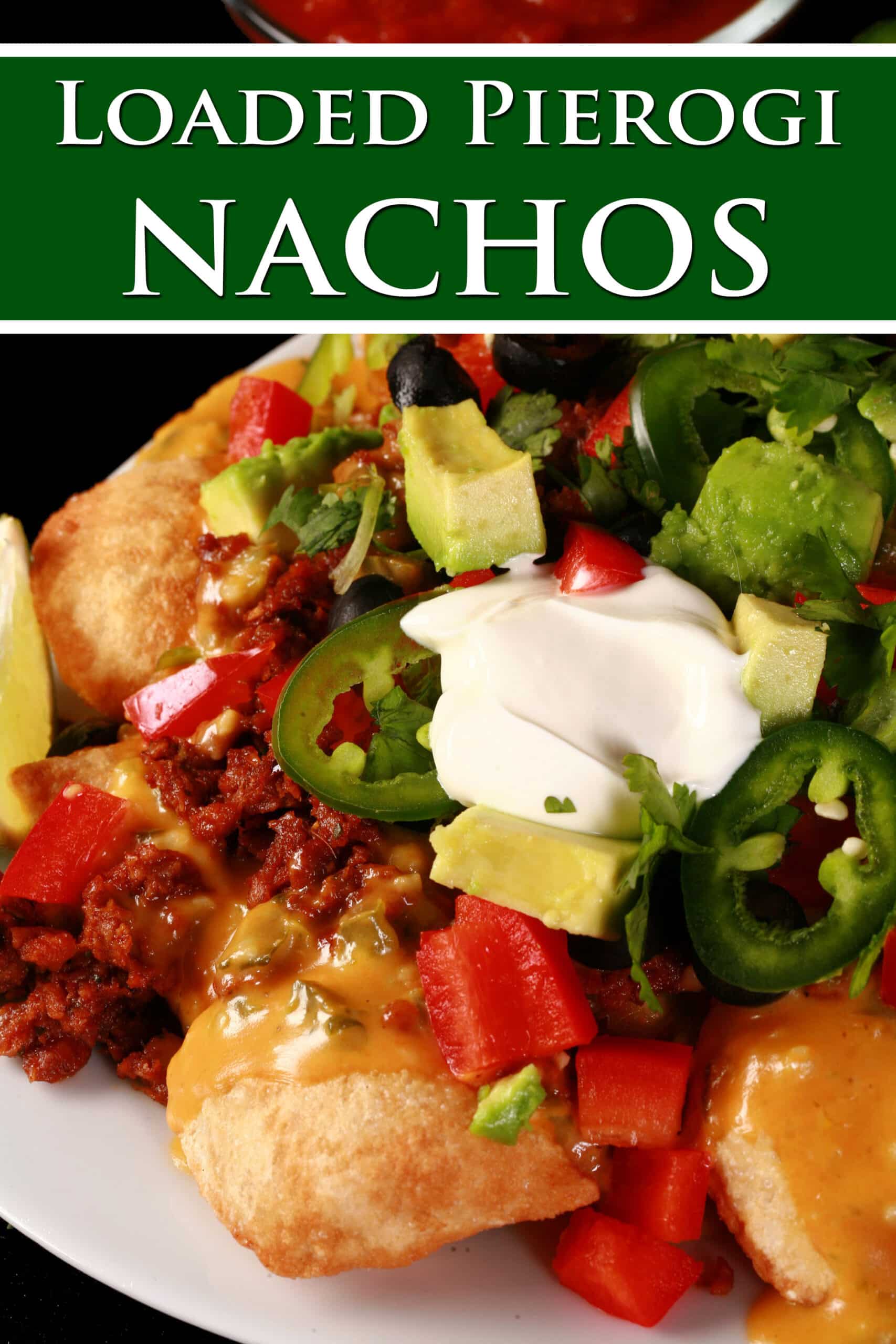 A platter of loaded perogy nachos. Overlaid text says loaded pierogi nachos.