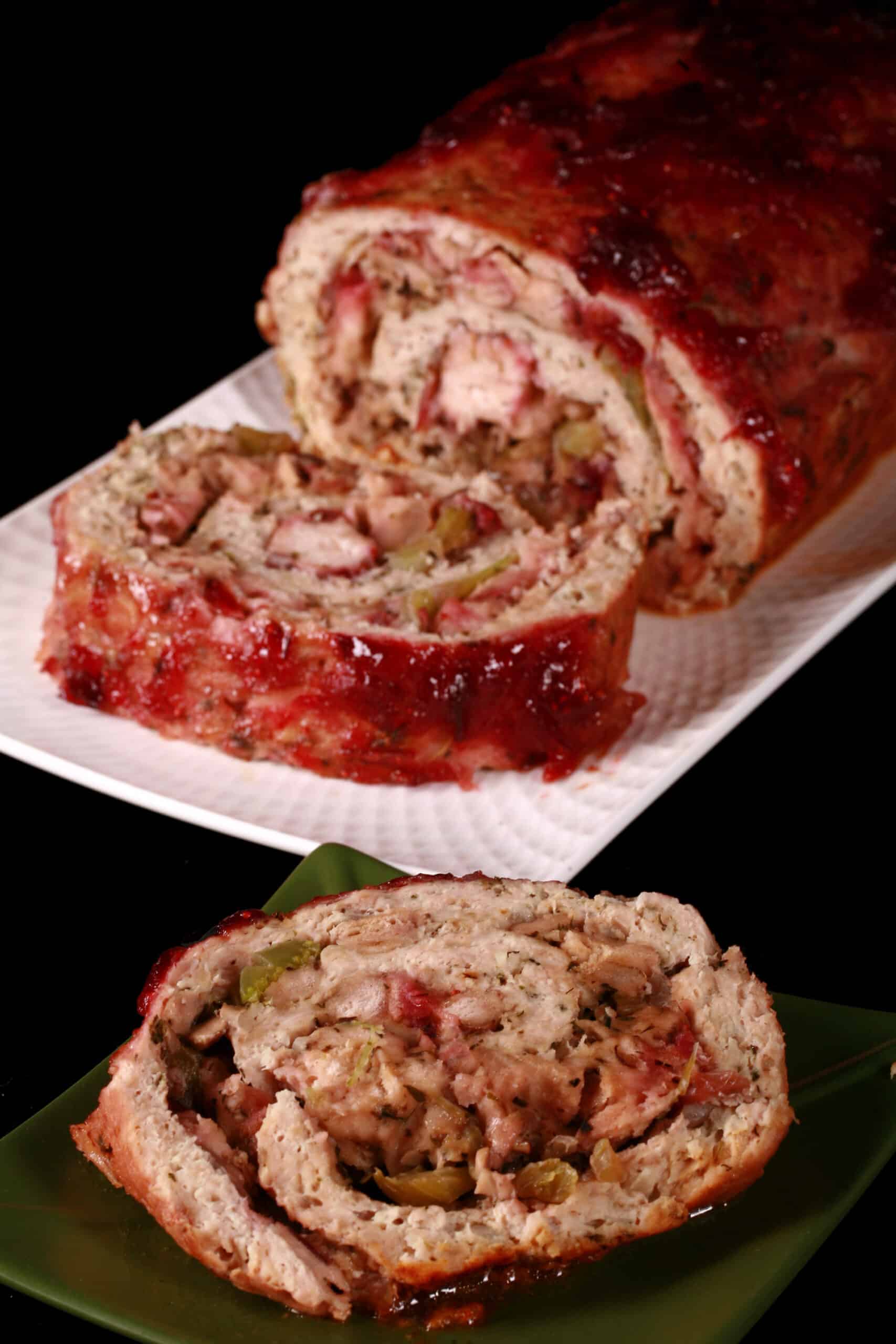 A rolled turkey thanksgiving stuffed meatloaf, with stuffing and cranberry sauce.